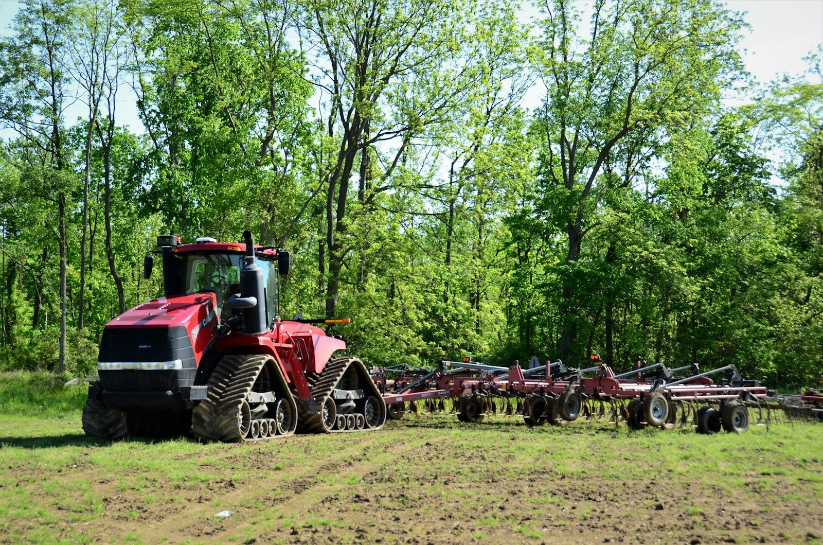Home a red tractor is parked in the middle of a field